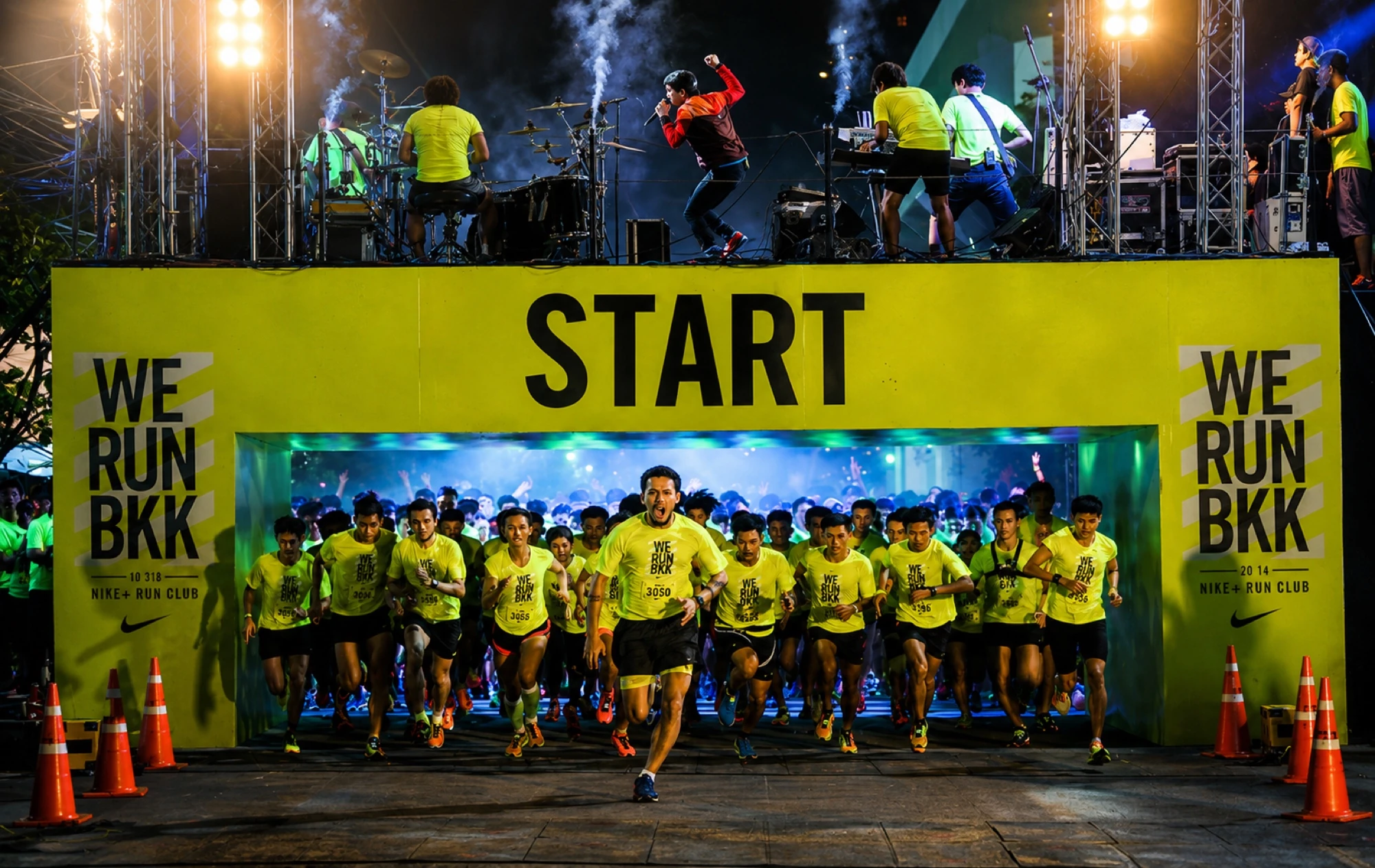 Nike We Run Bangkok start line with thousands of runners under stage lighting